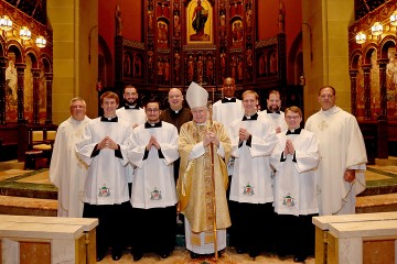 From Left to Right: Father Benedict O’Cinnsealaigh, Christopher Komoroski, Jeremy Stubbs, David Carvajal Casal, Ryan Furlong, Bishop Emeritus Edward J. Slattery, Benson Lokidiriyo, Robert Healey, Andrew Reckers, Kirby Rust and Father Anthony Brausch. (Photo by E L Hubbard)