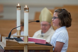 Annabeth Feltz, a fifth grader at St. Gabriel School, serves as a lector during the anniversary Mass.  (CT Photo/Colleen Kelley)
