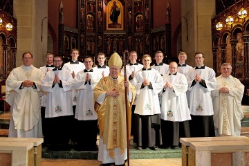 Photo Credit (l to r): Front Row: Bishop Joseph Binzer. Second Row: Father Anthony Brausch, Aaron Hess, John Stein, Edward Hoffmann, K. Scott Morgan, Louis Jacquemin, Father Benedict O'Cinnsealaigh. Back Row: Scott Brand, Elijah Puthoff, Michael Poussard, Kendall Ketterlin, Michael Kopolka, Anthony Marcelli. (Photo by E.L. Hubbard.)