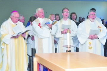 Bishop Joseph R. Binzer sings with Fathers Dave Brinkmoller, Ethan Moore and Steve DeSantos. (CT Photo/Jeff Unroe)