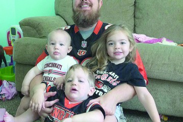 "I'm still a big sports fan" said Rod Dunlap, pictured in Bengals gear with his children. Dunlap is the head of Sports Ministry, a new focus for the Archdiocese. (Courtesy Photo)