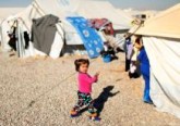 A displaced Iraqi child walks outside tents Dec. 9 at the Hassan Sham camp near Mosul. As Christians in the Middle East look back on 2016, they wonder if there will be much to celebrate amid mounting challenges, particularly for those displaced by conflicts in Iraq and Syria. (CNS photo/Ahmed Jadallah, Reuters)