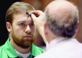 Mike Wolf marks a parishioner’s forehead with the sign of a cross during Ash Wednesday services at St. Peter in Chains Cathedral in Cincinnati Wednesday, Mar. 1, 2017. (CT PHOTO/E.L. HUBBARD)