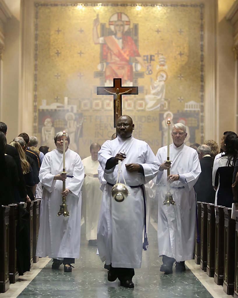 Elias Mwesigye leads the Recessional during the Rite of Election of Catechumens and of the Call to Continuing Conversion of Candidates who are preparing for Confirmation and Eucharist or Reception into Full Communion with the Roman Catholic Church at the Cathedral of St. Peter in Chains in Cincinnati Sunday, Mar. 5, 2017. (CT PHOTO/E.L. HUBBARD)