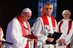 Pope Francis attends an ecumenical prayer service at the Lutheran cathedral in Lund, Sweden, Oct. 31. Also pictured are the Rev. Martin Junge, general secretary of the Lutheran World Federation, and Archbishop Antje Jackelen, primate of the Lutheran Church in Sweden. The pope made a two-day visit to Sweden to attend events marking the 500th anniversary of the Protestant Reformation. (CNS photo/Paul Haring)