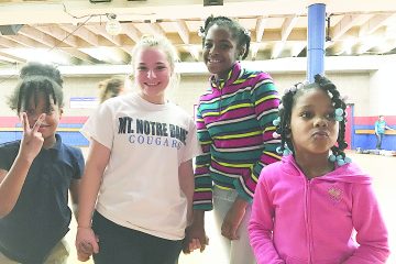 Kate Sampson poses with neighborhood children during a roller skating party in Over-the-Rhine. (Courtesy Photo)