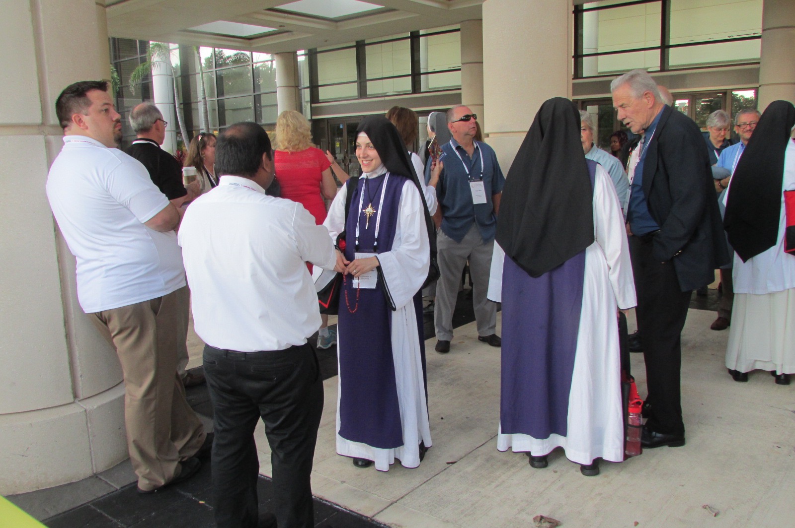 Local Children of Mary Sisters meet others waiting for the Eucharistic procession to begin (CT Photo/Gail Finke)