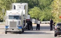 Police officers in San Antonio work a crime scene at Walmart July 23 after eight people were found dead inside an 18-wheeler truck. Several others were hospitalized in critical condition and the death toll reached 10 as of early July 24. Authorities say the truck was smuggling immigrants into the U.S. from Mexico and Central America. (CNS photo/Ray Whitehouse, Reuters)