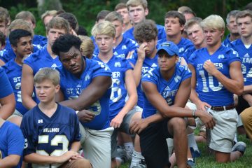 St. Xavier Bombers take a knee in prayer (CT Photo/Gail Finke)