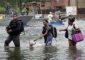 People walk through floodwaters from Hurricane Harvey Aug. 27 after being evacuated in Dickinson, Texas. (CNS photo/Rick Wilking, Reuters)
