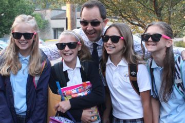 St. Andrew – St. Elizabeth Ann Seton School’s principal, Mr. Mark Wilburn, greeted sixth grade students, Sydnie Reith of Goshen, Avery May of Goshen, Grace Evans of Milford and Marin Warman of Goshen each with a pair of cool shades on their first day of the new school year. (Courtesy Photo)
