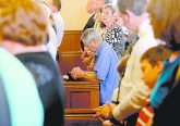 A parishioner kneels in prayer during the Feast of St. Bernard Mass and the closing of the One Hundred and Fiftieth Anniversary Year at St. Bernard of Clairvaux Catholic Church in Cincinnati Saturday, Aug. 19, 2017. (CT Photo/E.L. Hubbard)