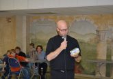 Father Kyle Schnippel giving the viewing party participants a primer before the show. (CT Photo/Greg Hartman)