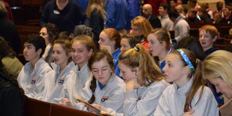 Students settle in and await the start of Catholic Schools Week Mass. (CT Photo/Greg Hartman)