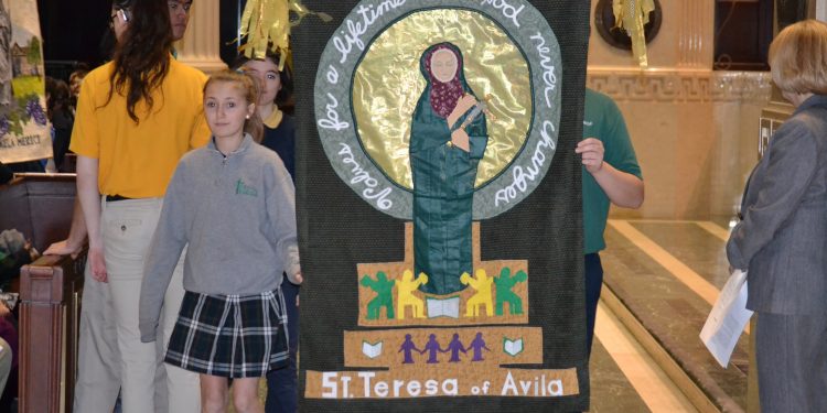 Representing St. Teresa of Avila School, students carry their banner (CT Photo/ Greg Hartman)