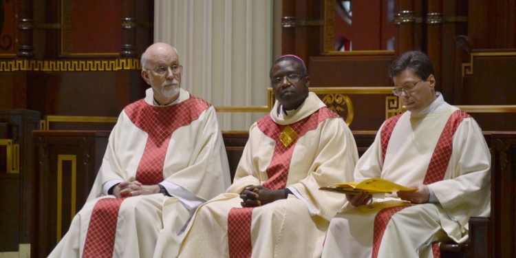 Seated from left to right, Father Len Wenke, Bishop Emmanuel Abbo from Cameroon, Deacon Mark Machuga. (CT Photo/Greg Hartman)