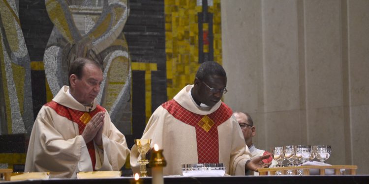 Archbishop Dennis M. Schnurr and Bishop Emmanuel Abbo of Cameroon during the Eucharistic Prayer. (CT Photo/Greg Hartman)