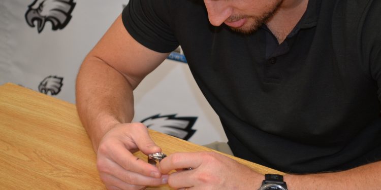 Brent examines some Lancer bling from State Championships. (CT Photo/Greg Hartman)