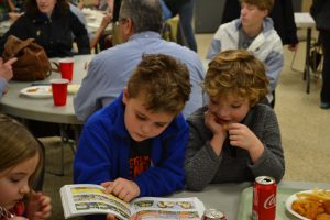 Having fun and reading a picture book at the St. Cecilia Fish Fry 2018 (CT Photo/Greg Hartman)