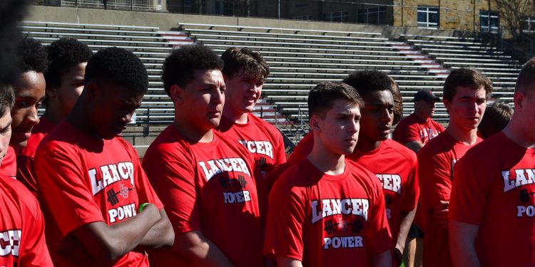 La Salle football players discerning the Stations of the Cross midfield (CT Photo/Greg Hartman)