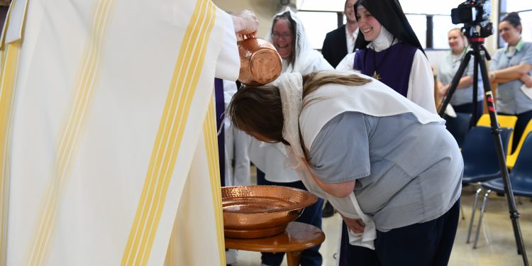 Lee Anna Rayas is baptized into the catholic church during Easter Mass at Dayton Correctional Institution (CT Photo/ Mark Bowen)