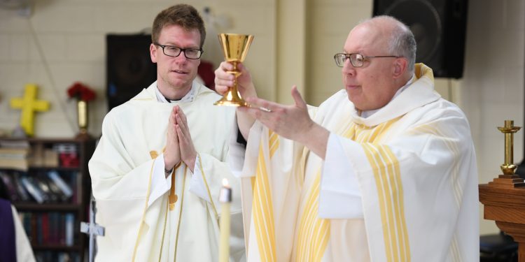 Bishop Binzer and Rev. Ethan Moore during Eucharistic Prayer. (CT Photo/Mark Bowen)