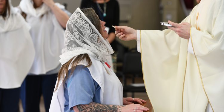 Teri Simon receives First Communion during Easter Mass. (CT Photo/Mark Bowen)