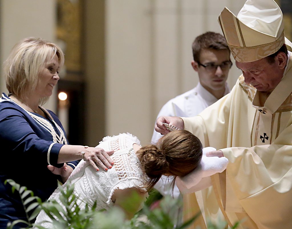 Alexandra Marie Markley is baptized by Archbishop Dennis Schnurr for the Easter Vigil in the Holy Night at the Cathedral of Saint Peter in Chains in Cincinnati, Holy Saturday, March 31, 2018. (CT Photo/E.L. Hubbard)