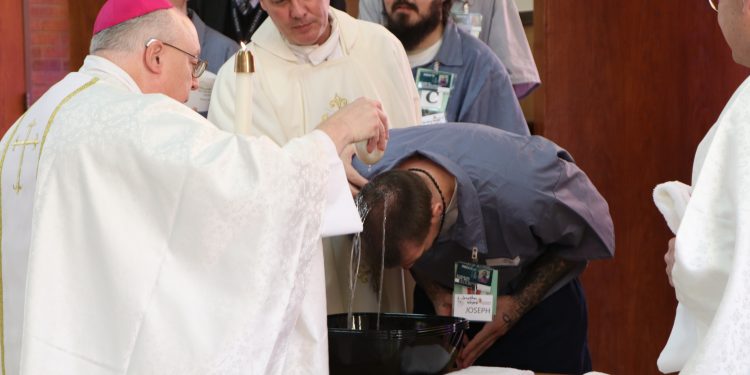 Jonathan Self is baptized during Easter Vigil at Lebanon Correctional Institution (CT Photo/Tom Uhlman)