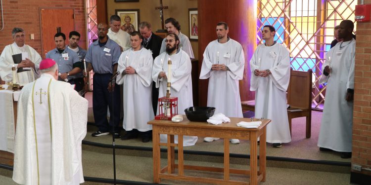 The Light of Christ to new members of the catholic church in the Archdiocese of Cincinnati (CT Photo/Tom Uhlman)