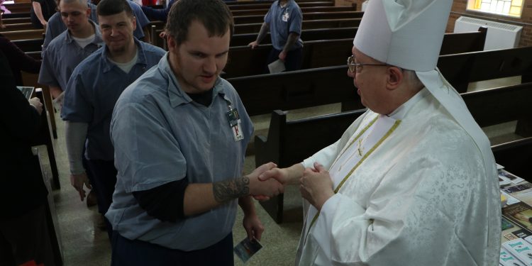 Bishop Binzer greets inmates after the Easter Vigil at Lebanon Correctional. (CT Photo/Tom Uhlman)