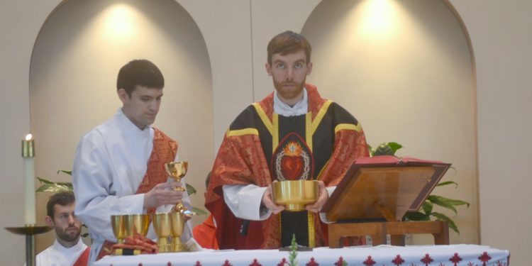 Rev. Jacob Willig prays over the gifts at his First Mass of Thanksgiving. (CT Photo/Greg Hartman)