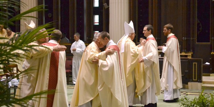 Sign of Peace,The ASrchbishop and all the concelebrating priests welcome the newly ordained into the order of presbyters. (CT Photo/Greg Hartman)