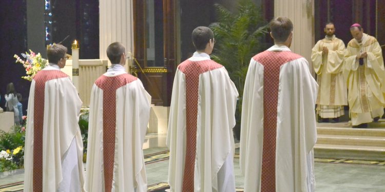 The newly ordained await their assignments (CT Photo/Greg Hartman)