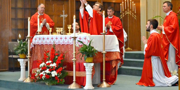 Rev. Craig Best during the Eucharistic Prayer: "Take this all of you and eat it...." (CT Photo/Greg Hartman