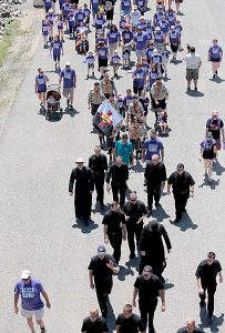 Priests from the Diocese of Covington and Archdiocese of Cincinnati walk during the Cross the Bridge for Life celebration on Riverboat Row in Newport, Sunday, June 3, 2018. (CT Photo/E.L. Hubbard)