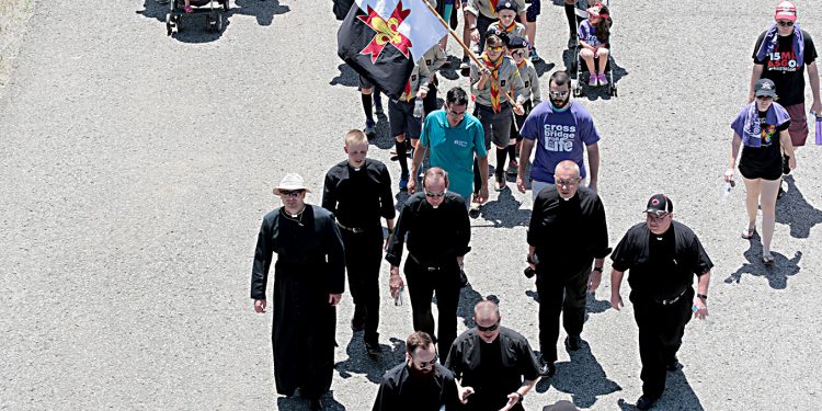 Priests from the Diocese of Covington and Archdiocese of Cincinnati walk during the Cross the Bridge for Life celebration on Riverboat Row in Newport, Sunday, June 3, 2018. (CT Photo/E.L. Hubbard)