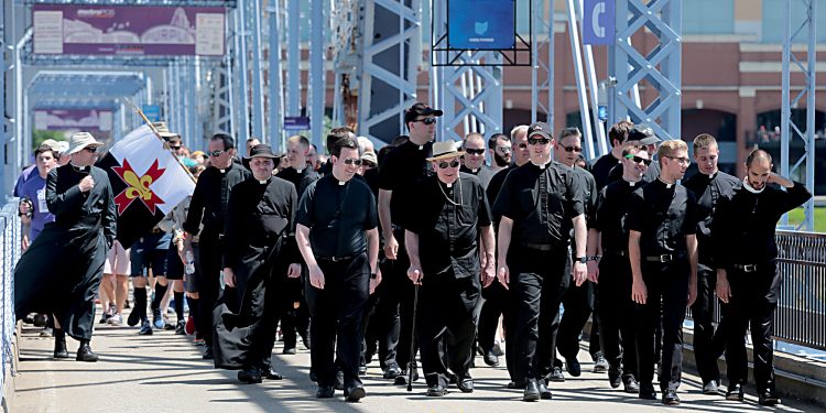 Priests from the Diocese of Covington and Archdiocese of Cincinnati cross the Purple People Bridge during the Cross the Bridge for Life celebration on Riverboat Row in Newport, Sunday, June 3, 2018. (CT Photo/E.L. Hubbard)