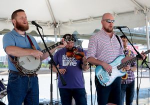 The band Easter Rising plays during the Cross the Bridge for Life celebration on Riverboat Row in Newport, Sunday, June 3, 2018. (CT Photo/E.L. Hubbard)