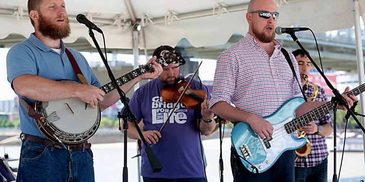 The band Easter Rising plays during the Cross the Bridge for Life celebration on Riverboat Row in Newport, Sunday, June 3, 2018. (CT Photo/E.L. Hubbard)