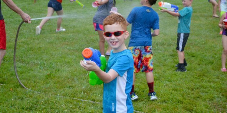 Photographer's note: very appreciative as this young man was poised to fire, and didn't to save me from a drenching! (CT Photo/Greg Hartman)