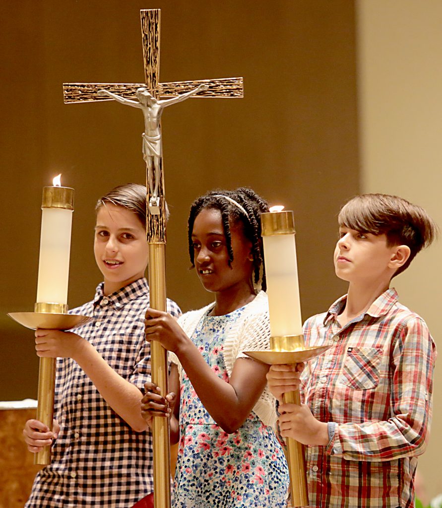 Max Fink, 12, Kenya Howard, 10, and Jake Fink, 10, lead the procession for the first annual Laudato Si’ Community recognitions ceremony at Good Shepherd Church in Cincinnati Monday, June 18, 2018. (CT Photo/E.L. Hubbard)