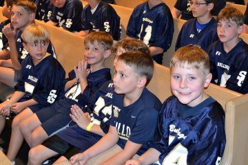 Boys from the St. Gertrude Football squad await praying the rosary. (CT Photo/Greg Hartman)