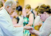 Father William Dorrmann delivers the Holy Eucharist to a parishioner during the St. Aloysius Parish 150th Anniversary Mass in Shandon Saturday, June 2, 2018. (CT Photo/E.L. Hubbard)