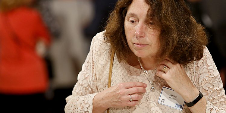 Denice Hertlein tries on a necklace during RetroFittings 2018, a St. Vincent de Paul fundraising event, at Music Hall in Cincinnati Thursday, Oct. 18, 2018. (CT Photo/E.L. Hubbard)