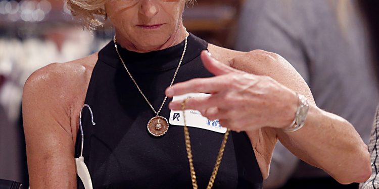 Martha Rhoade examines a necklace during RetroFittings 2018, a St. Vincent de Paul fundraising event, at Music Hall in Cincinnati Thursday, Oct. 18, 2018. (CT Photo/E.L. Hubbard)