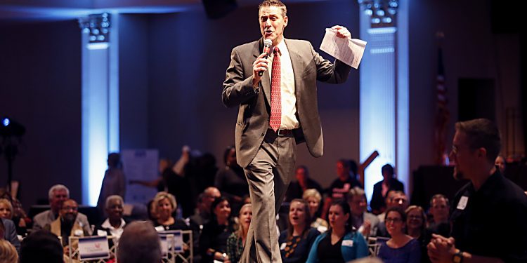 Warm 98 DJ Jim Day emcees the live auction during RetroFittings 2018, a St. Vincent de Paul fundraising event, at Music Hall in Cincinnati Thursday, Oct. 18, 2018. (CT Photo/E.L. Hubbard)