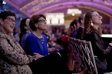 Shelly Maxwell, Jackie Hirt, and Holly Mazzocca watch the fashion show during RetroFittings 2018, a St. Vincent de Paul fundraising event, at Music Hall in Cincinnati Thursday, Oct. 18, 2018. (CT Photo/E.L. Hubbard)