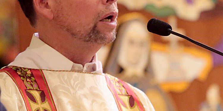 Deacon Mark Alexander proclaims the Gospel for the Mass of Thanksgiving for the 150th Anniversary of the Arrival of the Little Sisters of the Poor in Cincinnati at St. Monica-St. George Parish in Cincinnati Saturday, Oct. 20, 2018. (CT Photo/E.L. Hubbard)