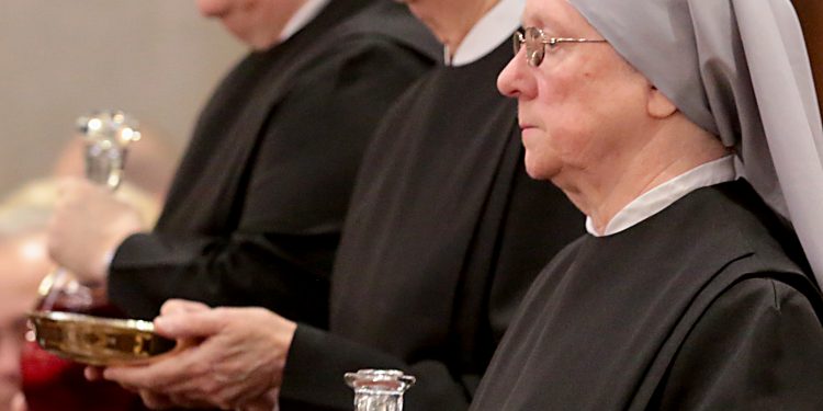 Mother Francis, Mother Provincial Lorraine, and Mother Mary Sylvia carry the Gifts for the Mass of Thanksgiving for the 150th Anniversary of the Arrival of the Little Sisters of the Poor in Cincinnati at St. Monica-St. George Parish in Cincinnati Saturday, Oct. 20, 2018. (CT Photo/E.L. Hubbard)